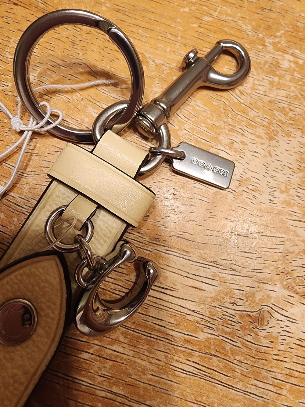 Coach Trigger Snap Bag Charm in Signature Canvas featuring a sleek Beige/silver